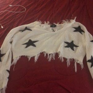 A cropped white sweater with stars on it